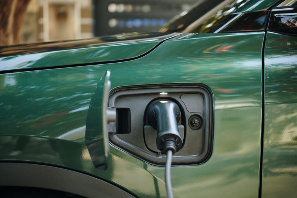 Plug Inserted in Electric Car