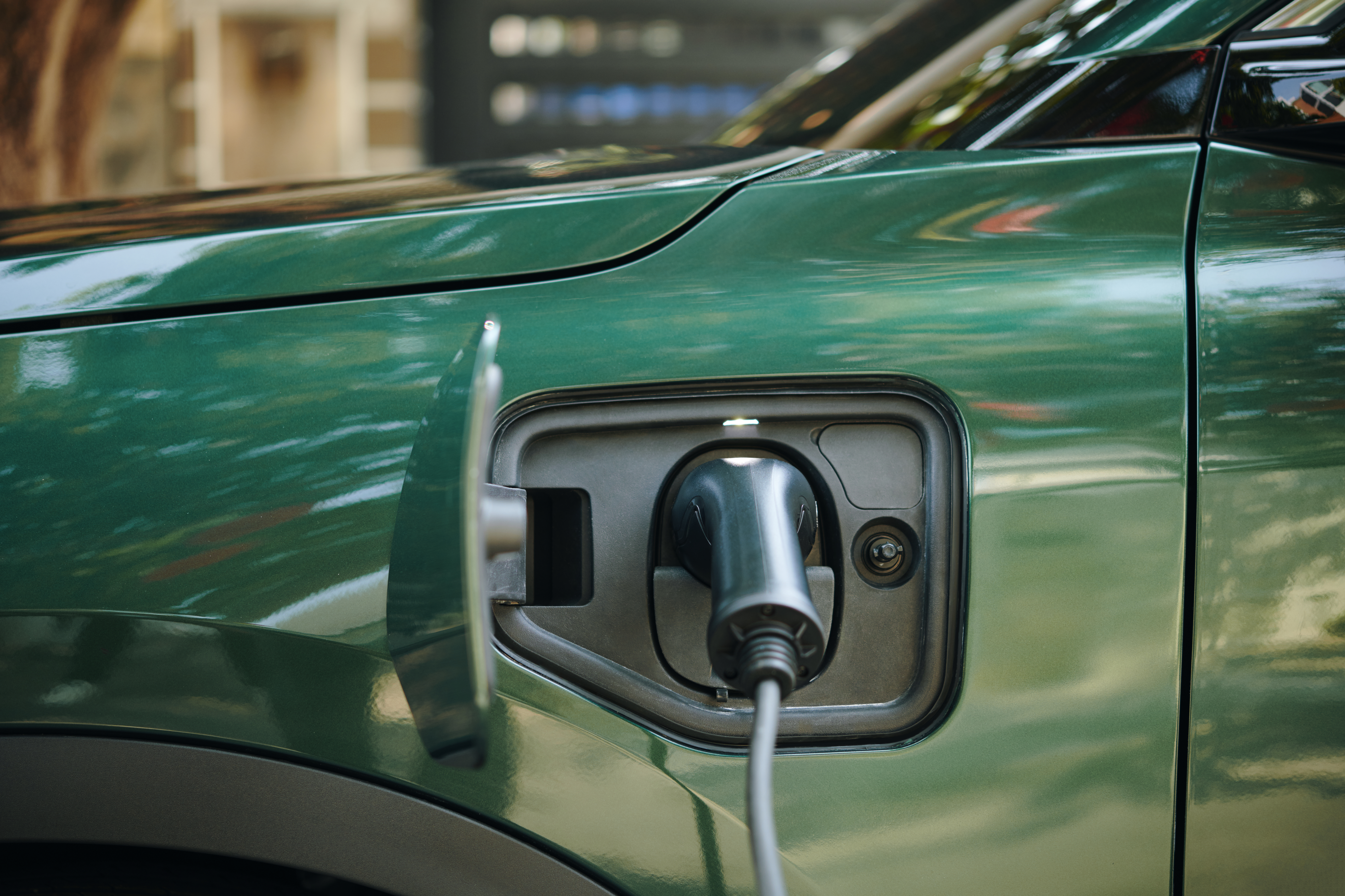 Plug Inserted in Electric Car