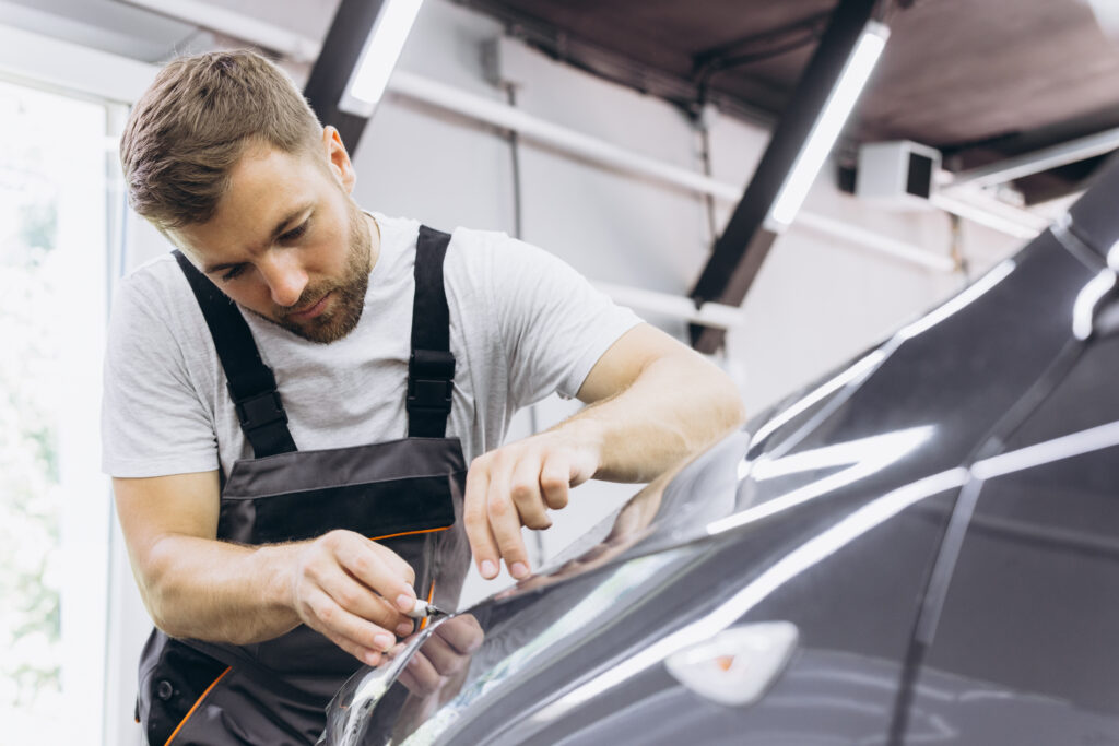 Detailing film paint protection, male specialist cutting and wra